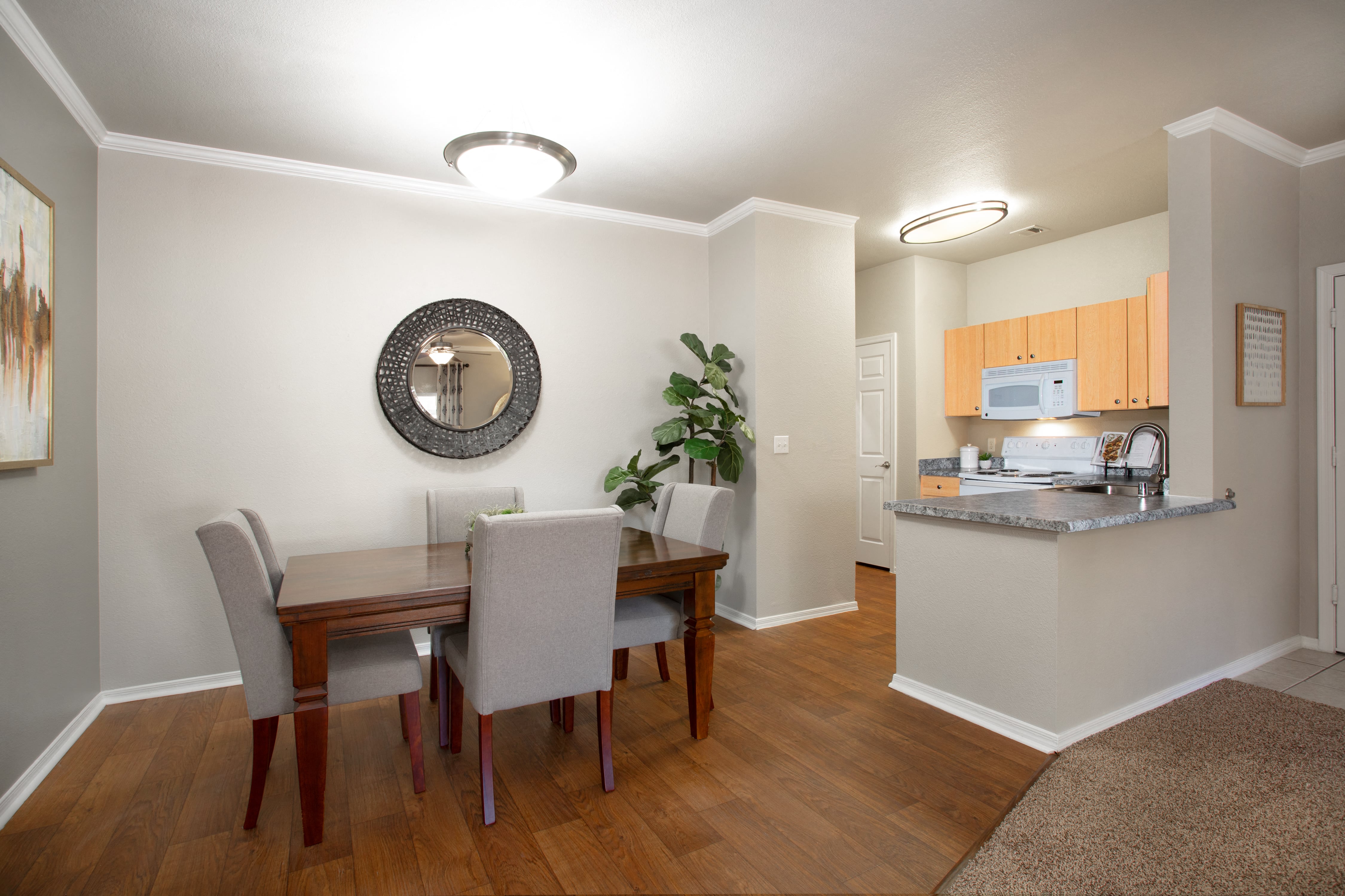 a dining room and kitchen with a table and chairs