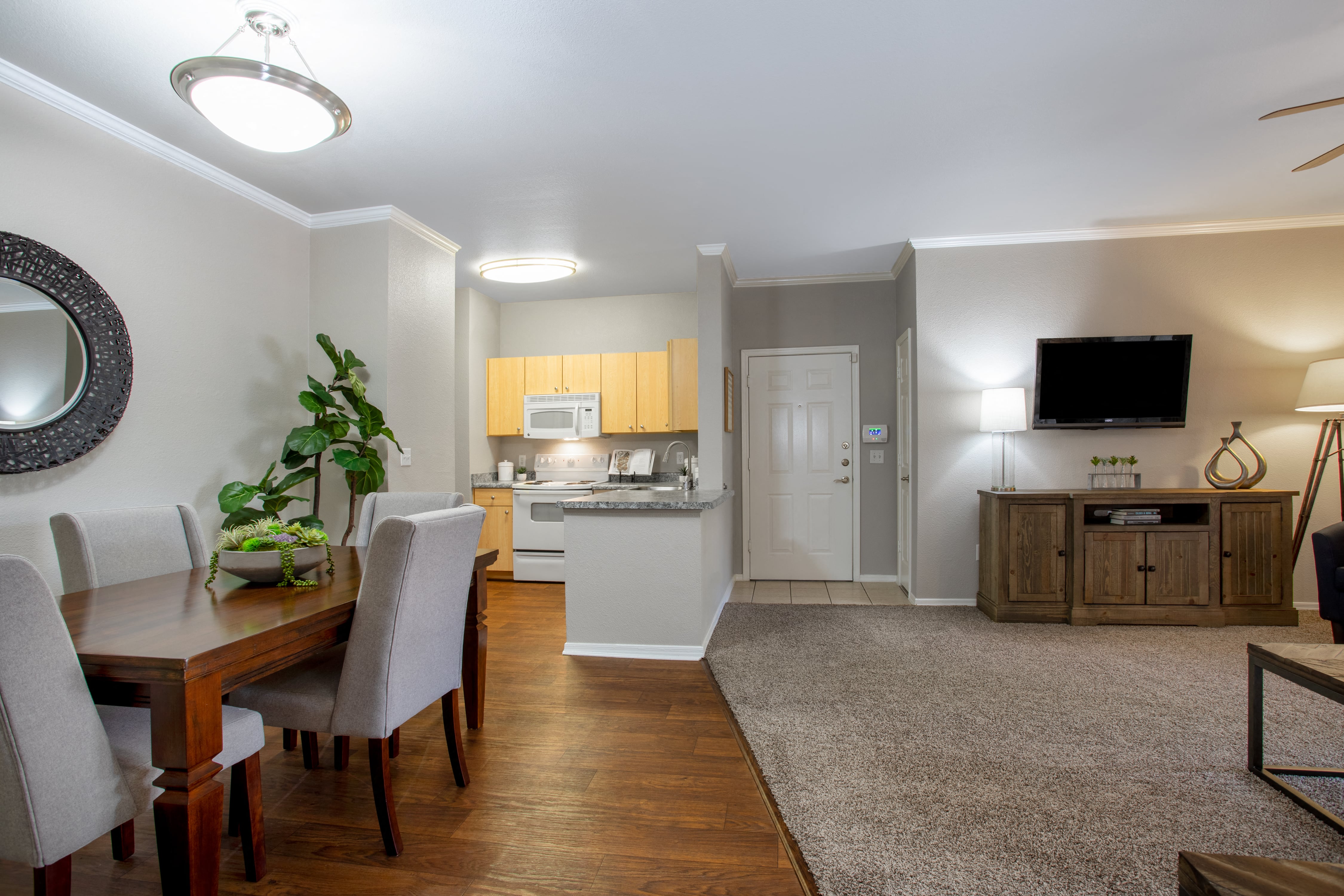 a living room and dining room with a table and chairs