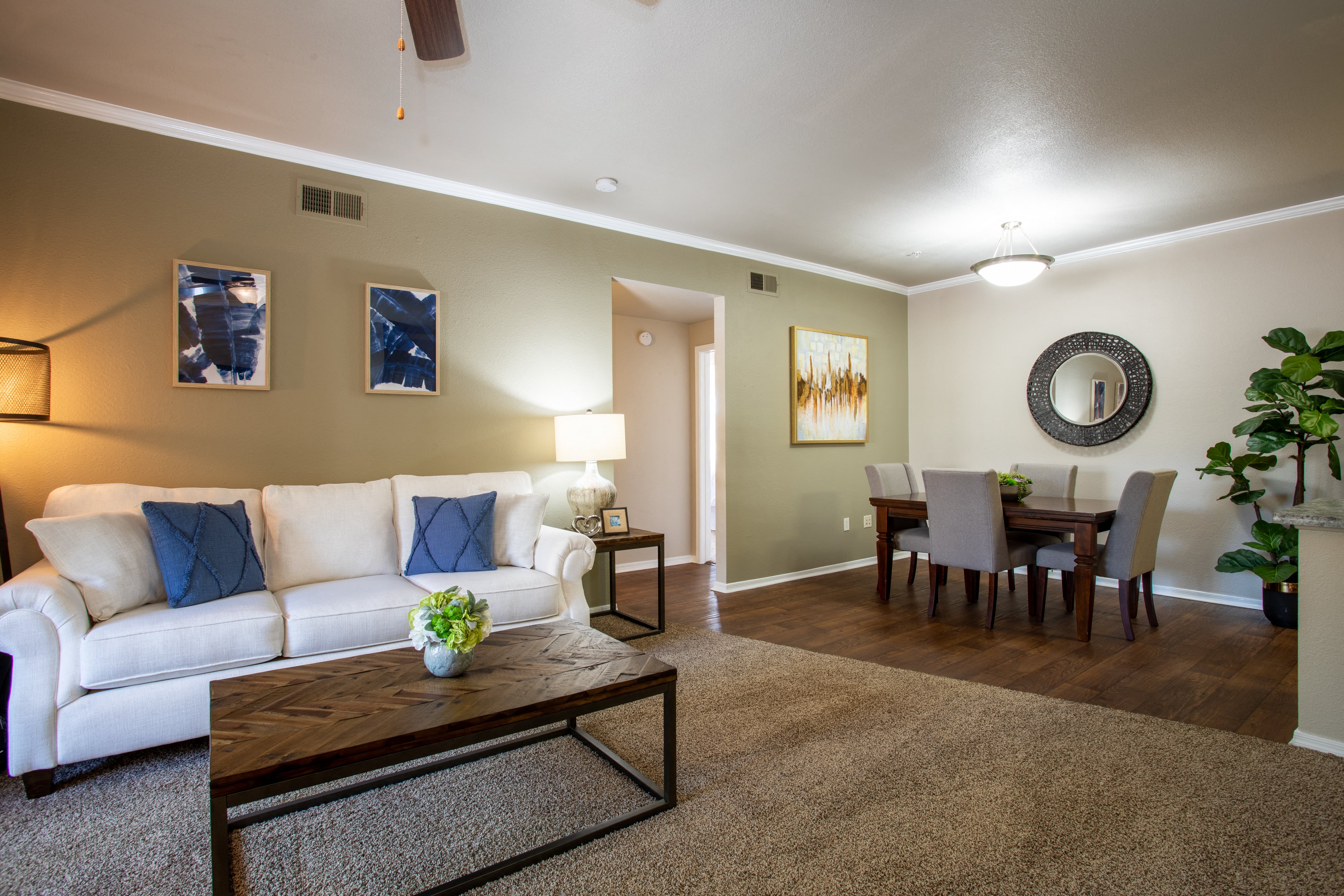 a living room and dining room with a couch and a table