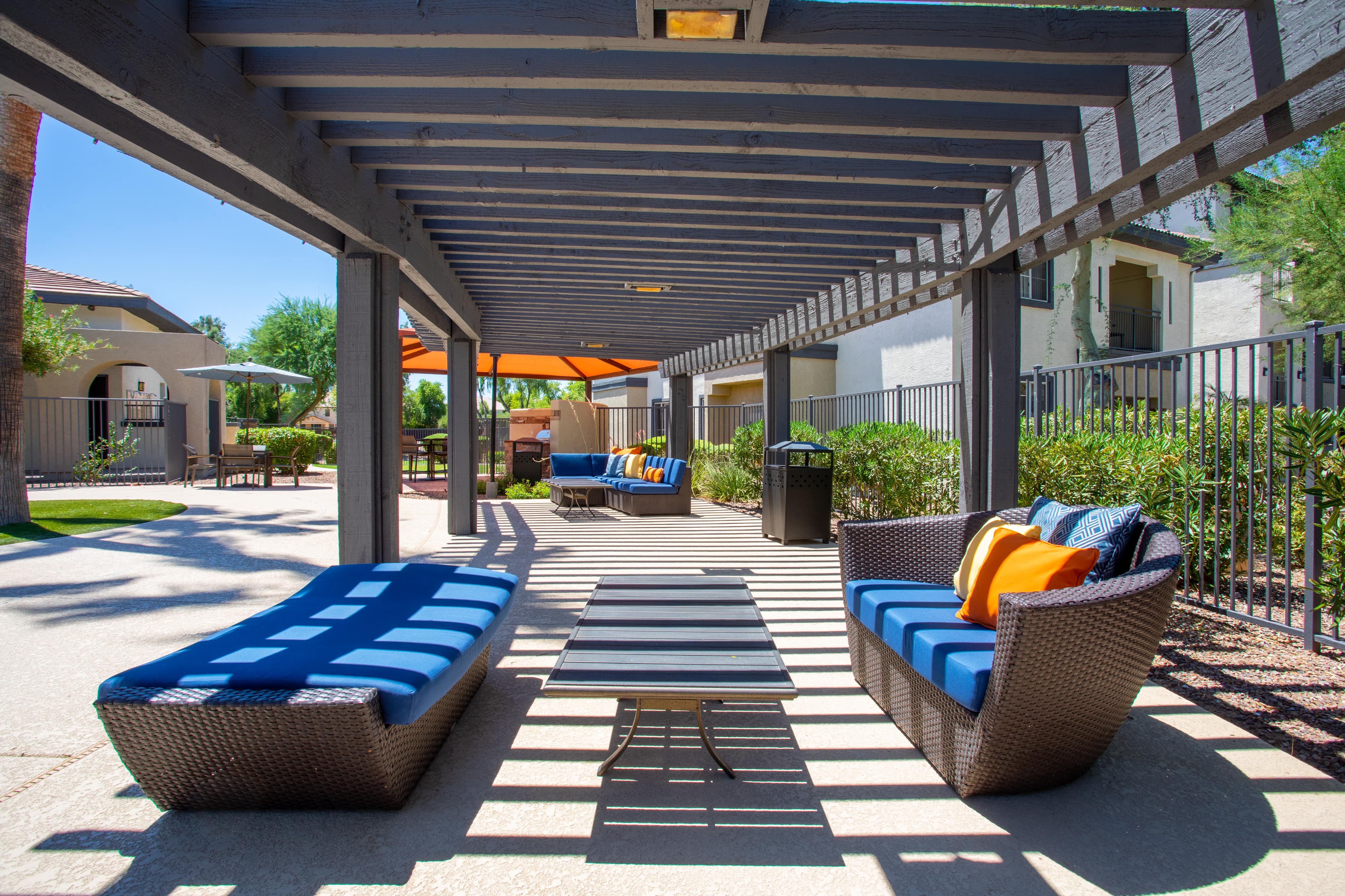 a covered patio with couches and chairs