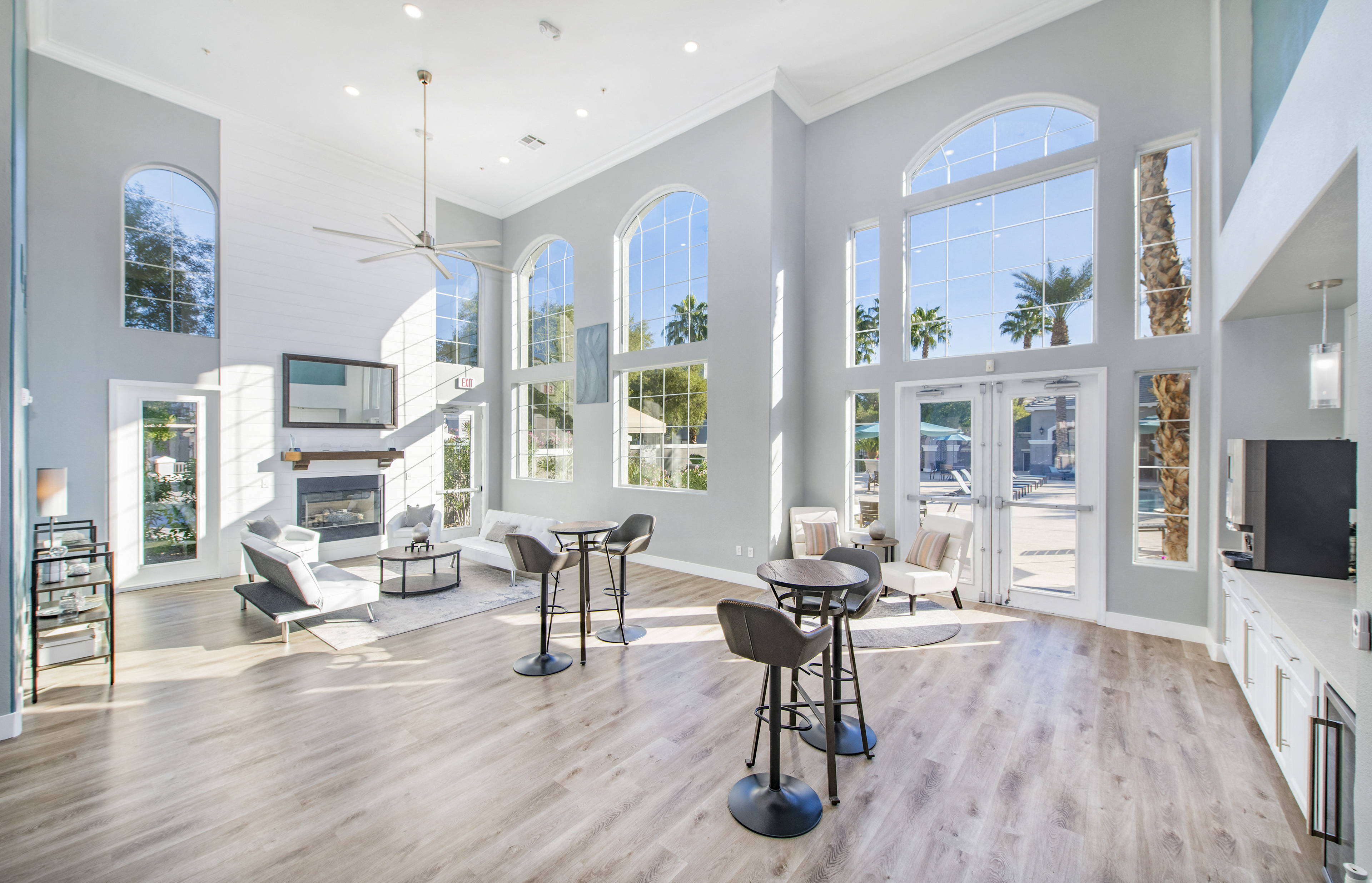 a large living room with high ceilings and large windows