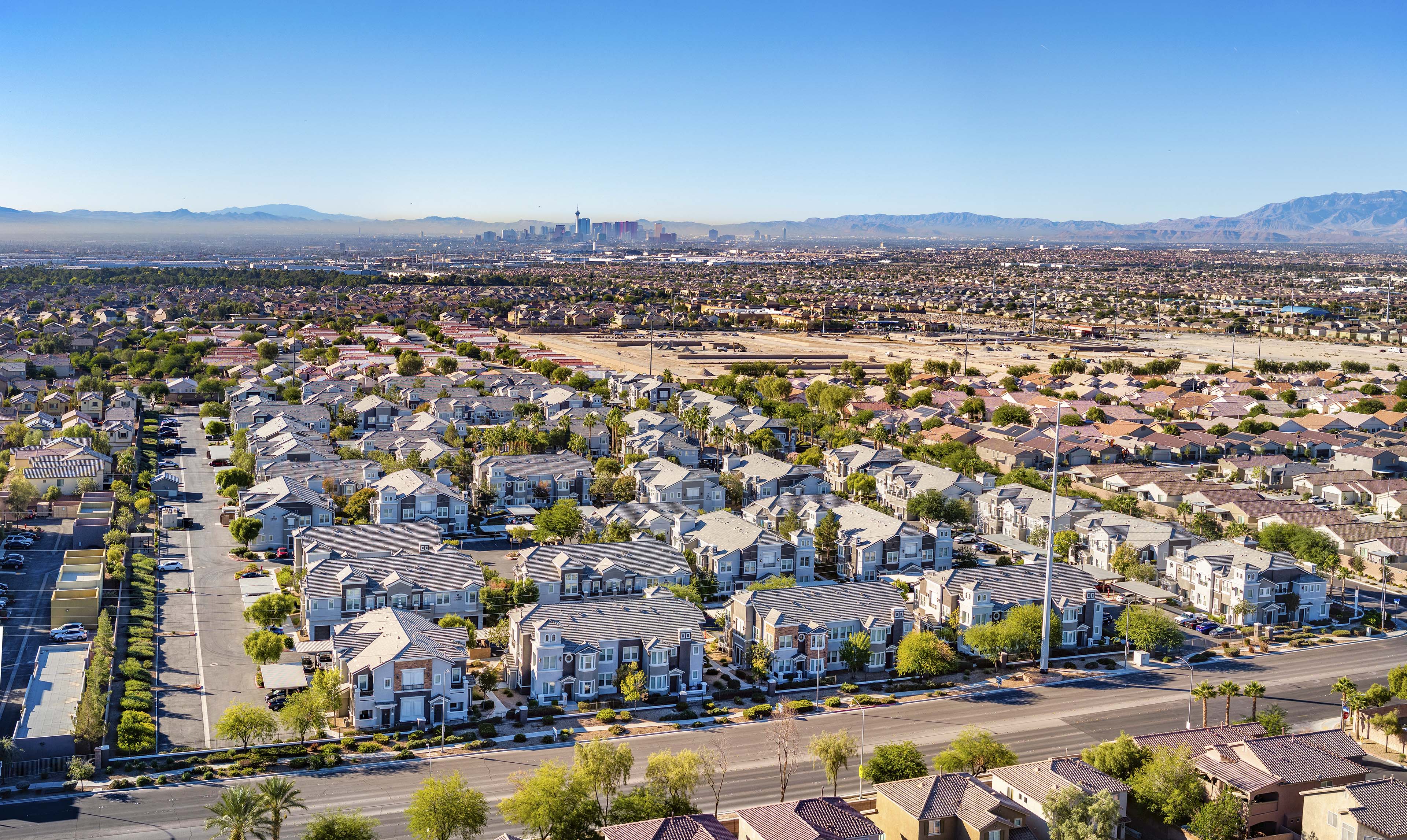 an aerial view of a suburb of a city with suburban homes