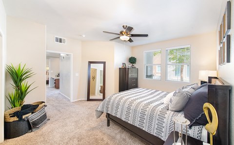a bedroom with a bed and a ceiling fan