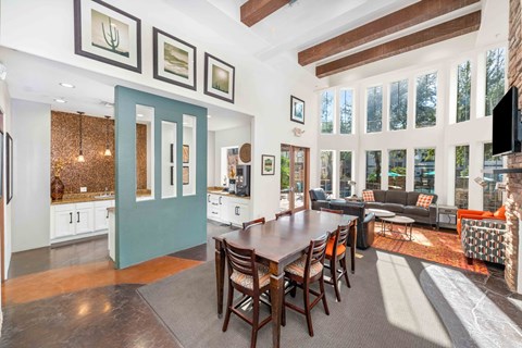 A dining room with a long table and chairs.