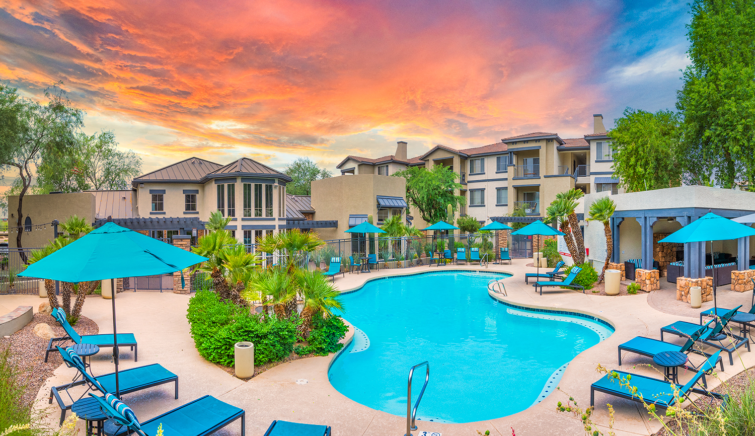 a swimming pool with umbrellas and chairs at the resort