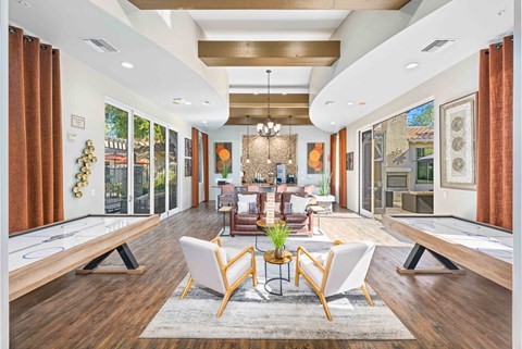 A well-lit, modern living room with a pool table and comfortable seating.