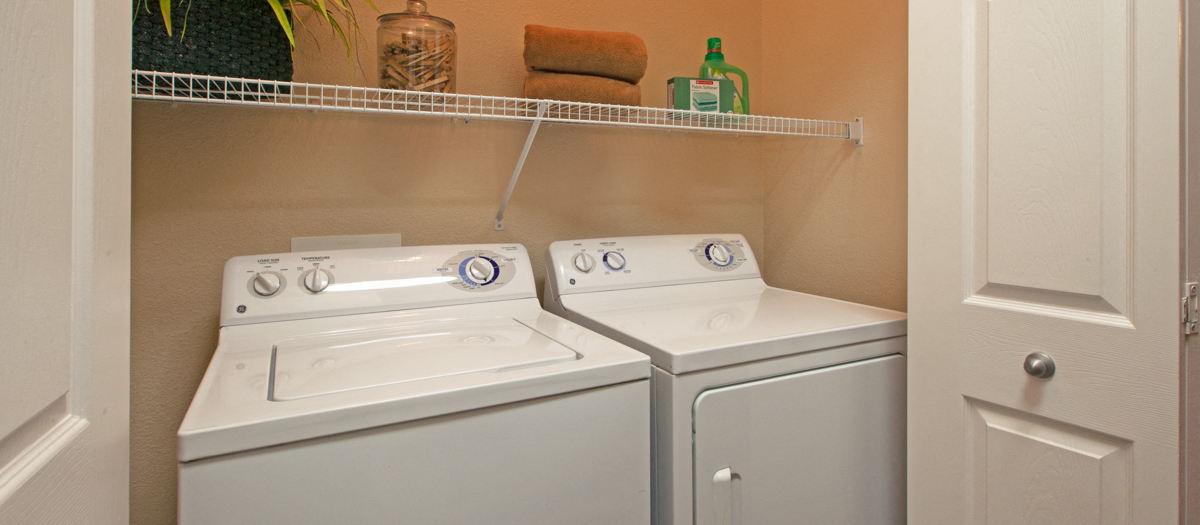 two washers and dryers in the laundry room of a home