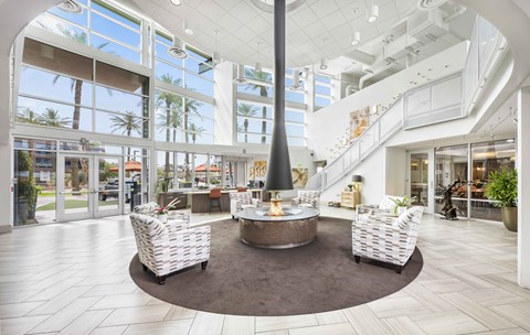A large, open living room with a fireplace and a spiral staircase.