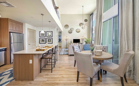 A modern kitchen with a dining table and chairs.