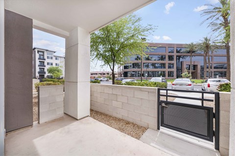 A modern building with a balcony overlooking a parking lot.
