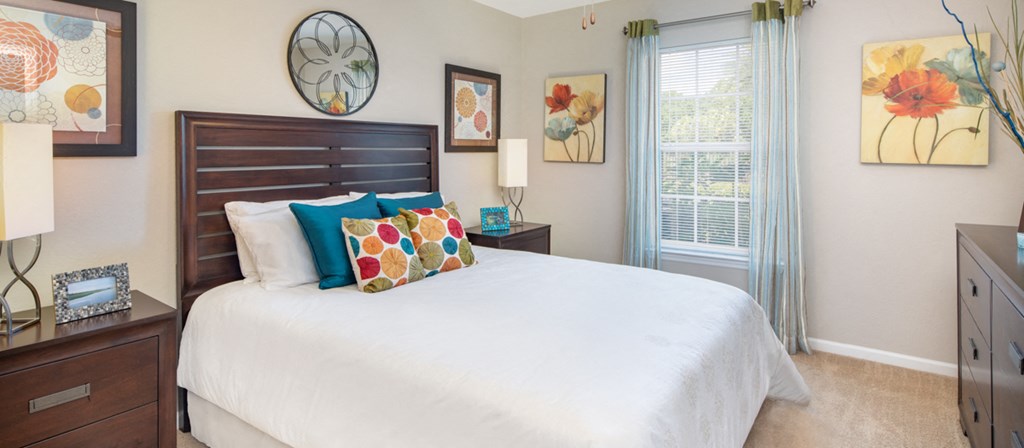 a bedroom with a large bed and a window