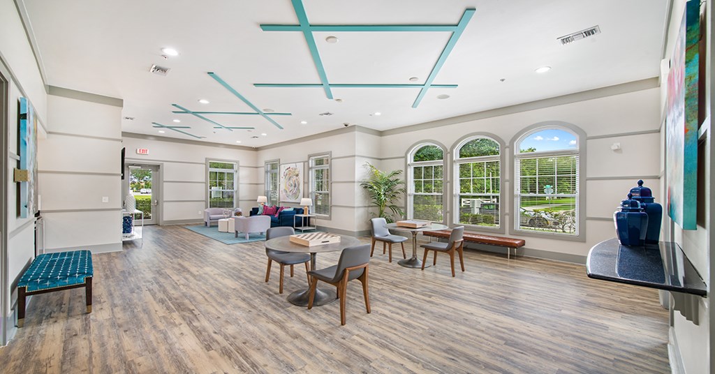 A spacious room with wooden floors and a large window.