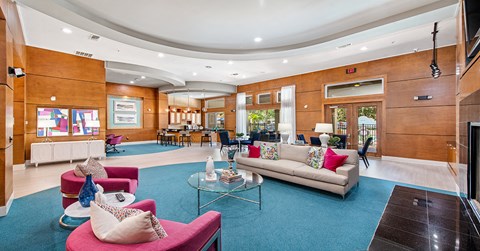 A living room with a couch, chairs, and a coffee table.