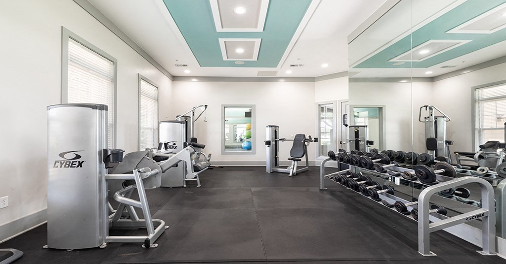 A gym with a variety of equipment including a CYBEX machine.
