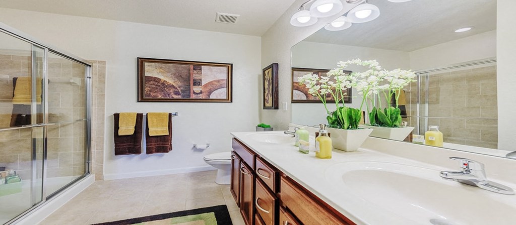 a bathroom with a sink and a shower and a toilet