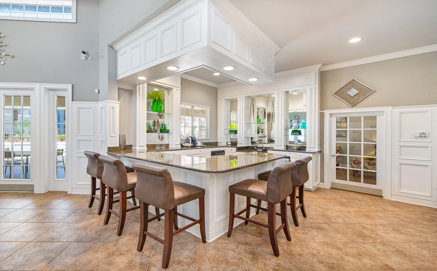 a large kitchen with a large island and chairs