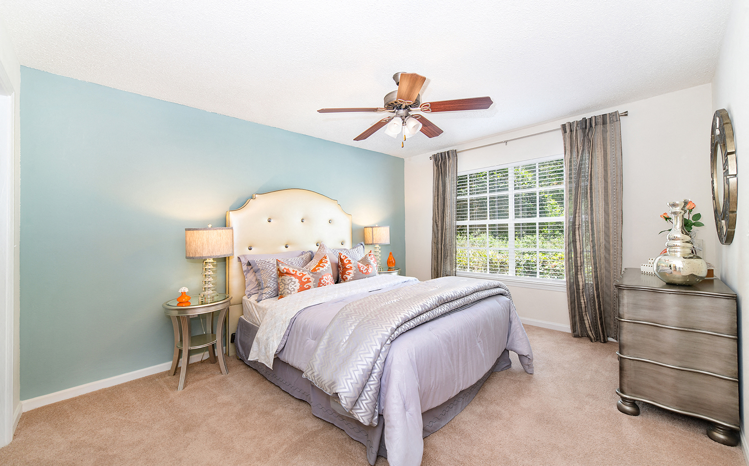a bedroom with a bed and a ceiling fan