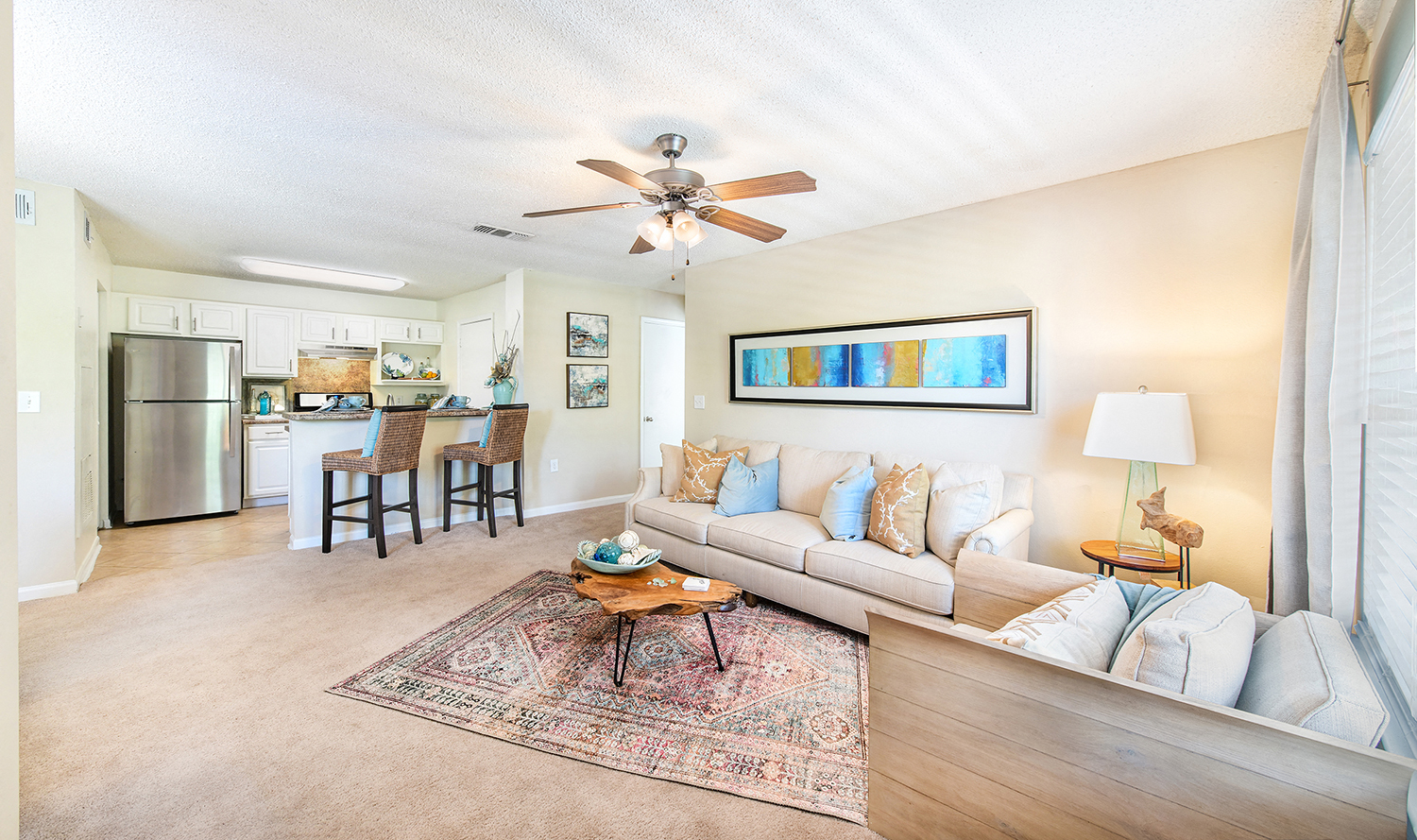 a living room with a couch and a ceiling fan