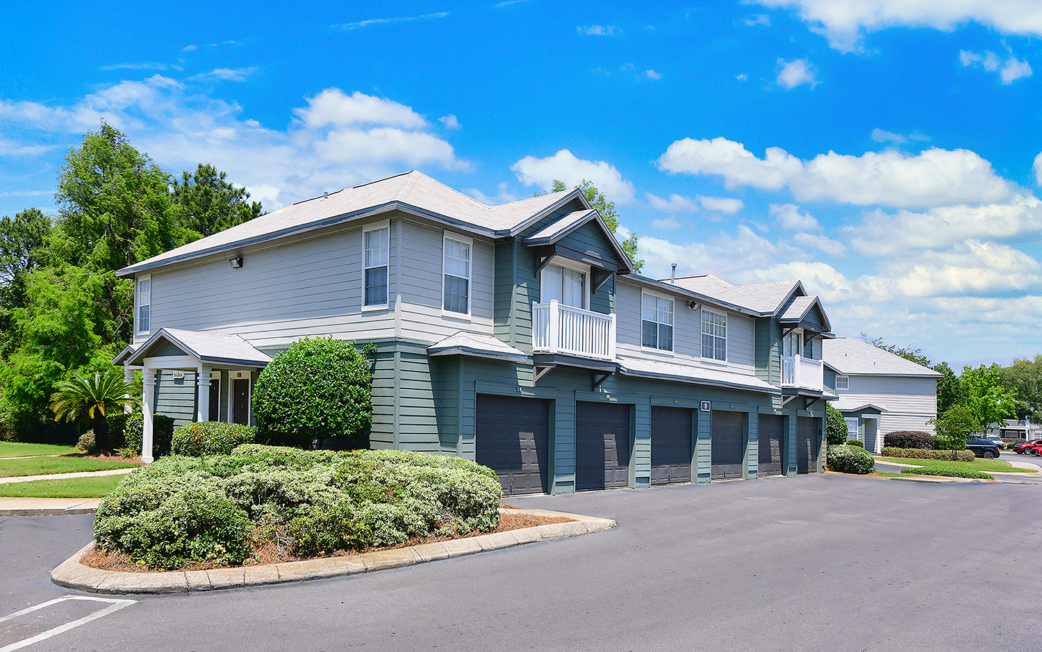 a blue and white house with a parking lot