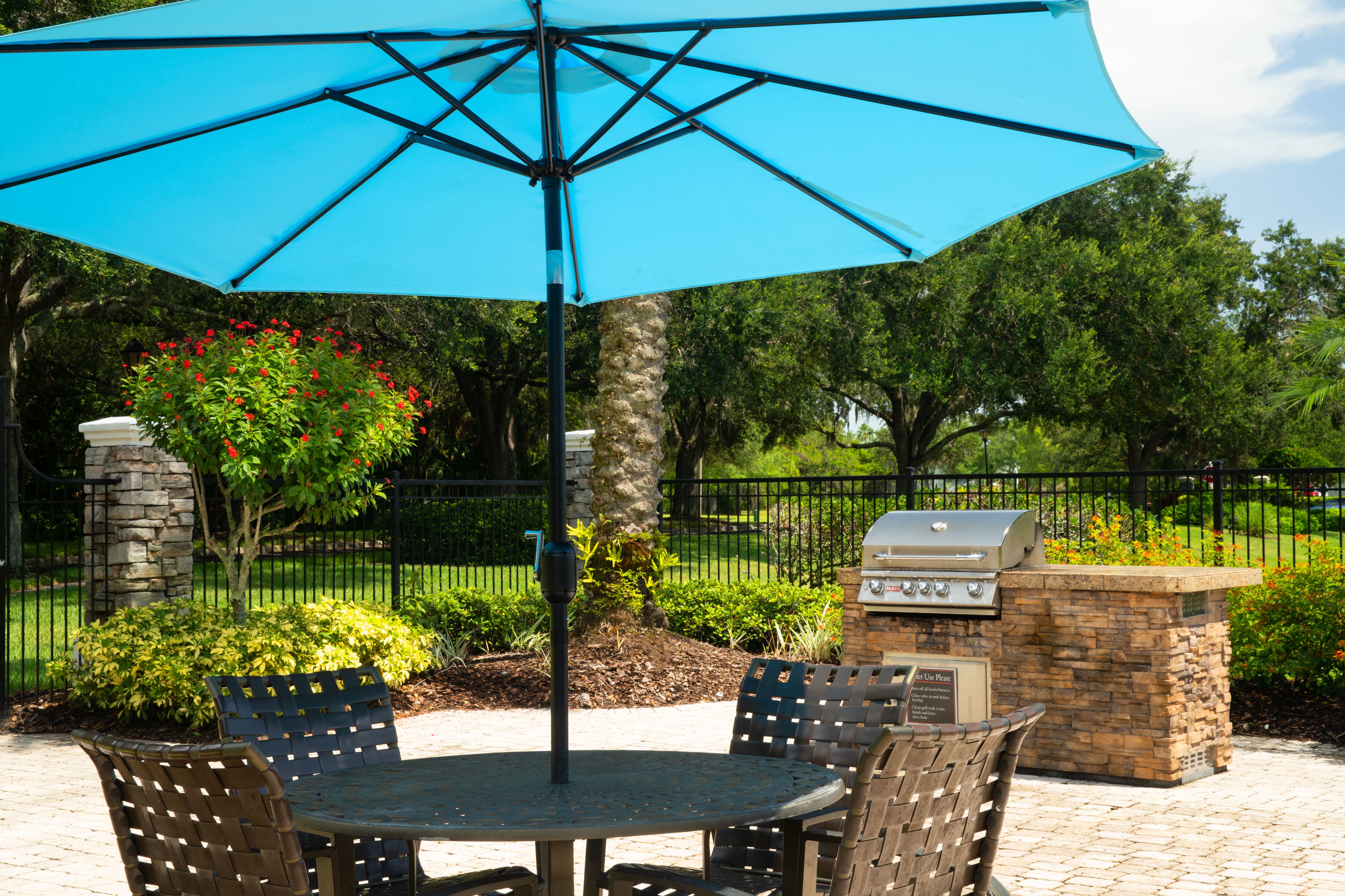a patio with a table and chairs under an umbrella