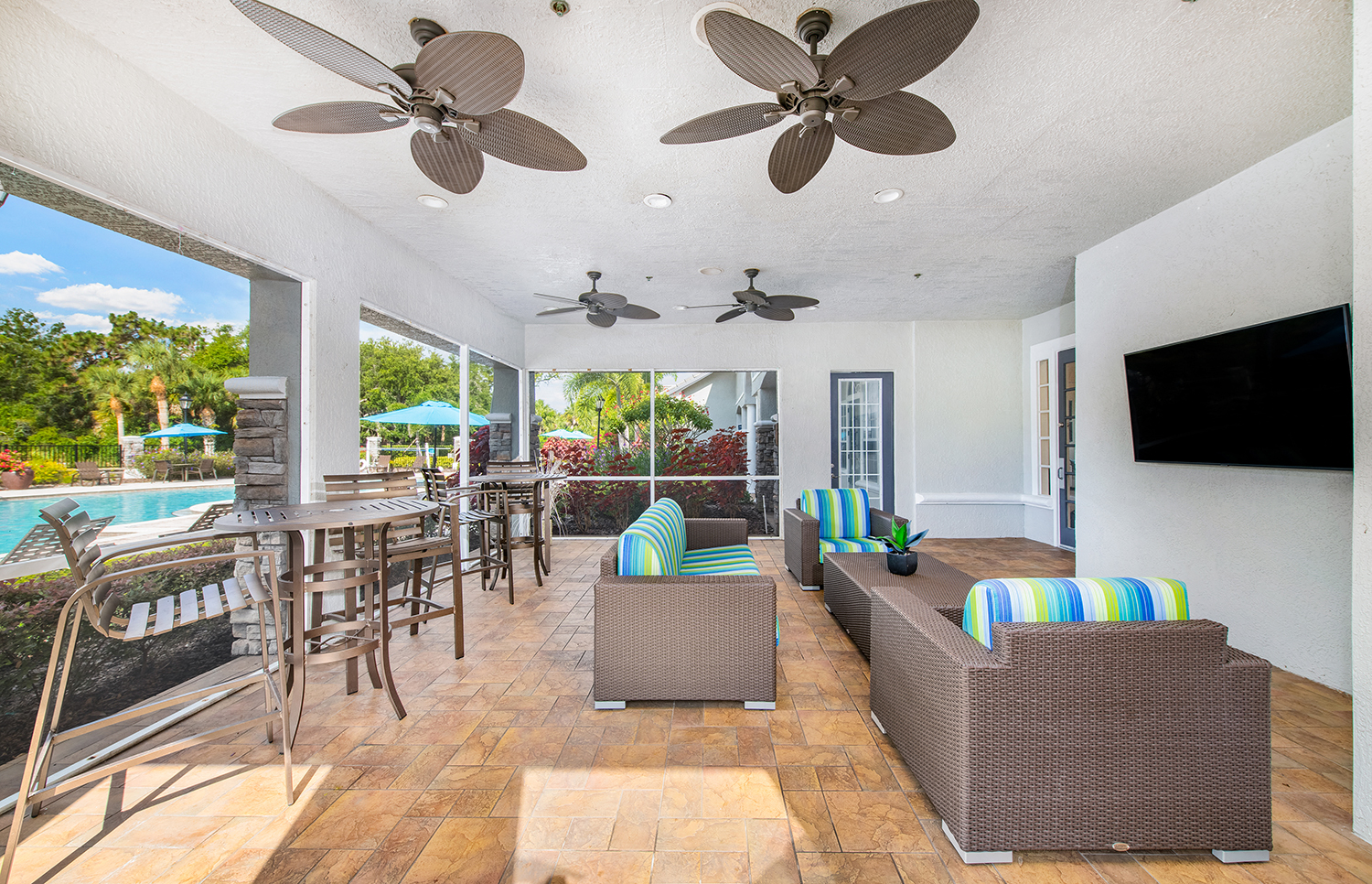 a living room with couches and chairs and a pool