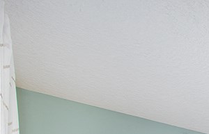 a bedroom with a large bed and a ceiling fan