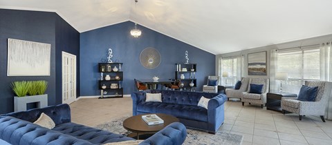 a living room with blue furniture and blue walls