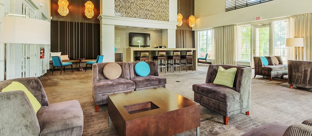 a living room with couches and chairs and a table