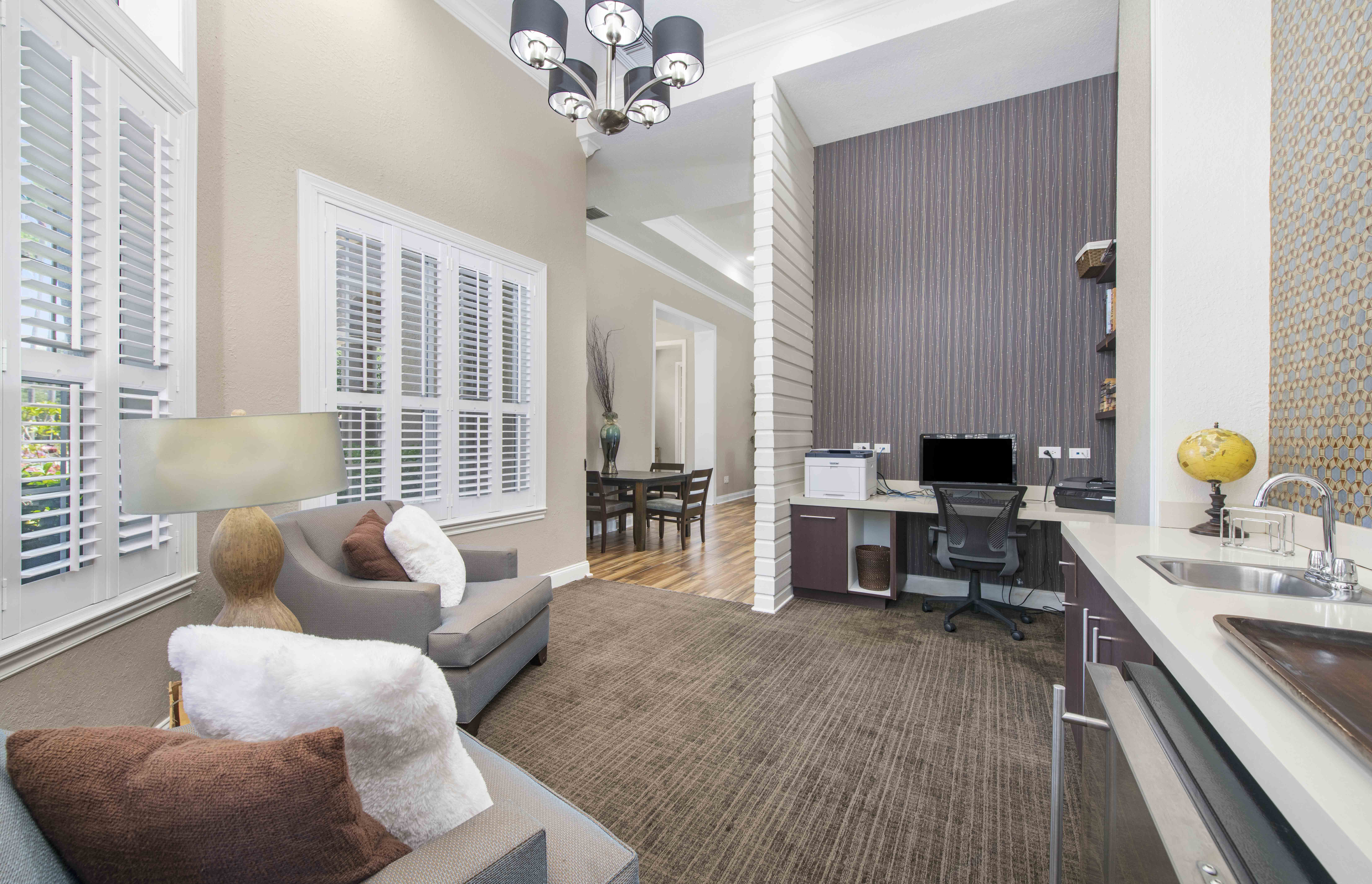 a living room with a couch and a desk