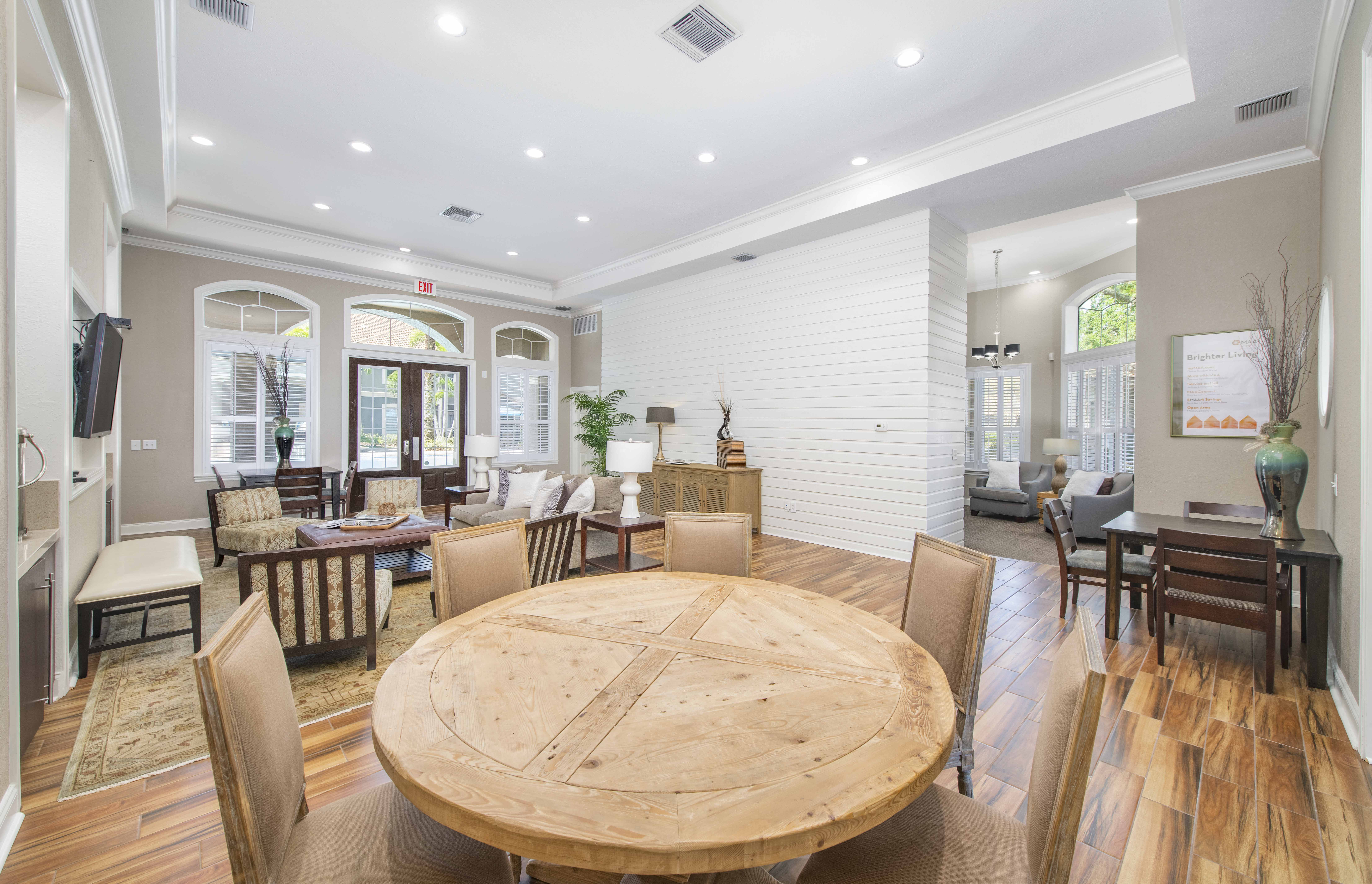 a dining room with a wooden table and chairs
