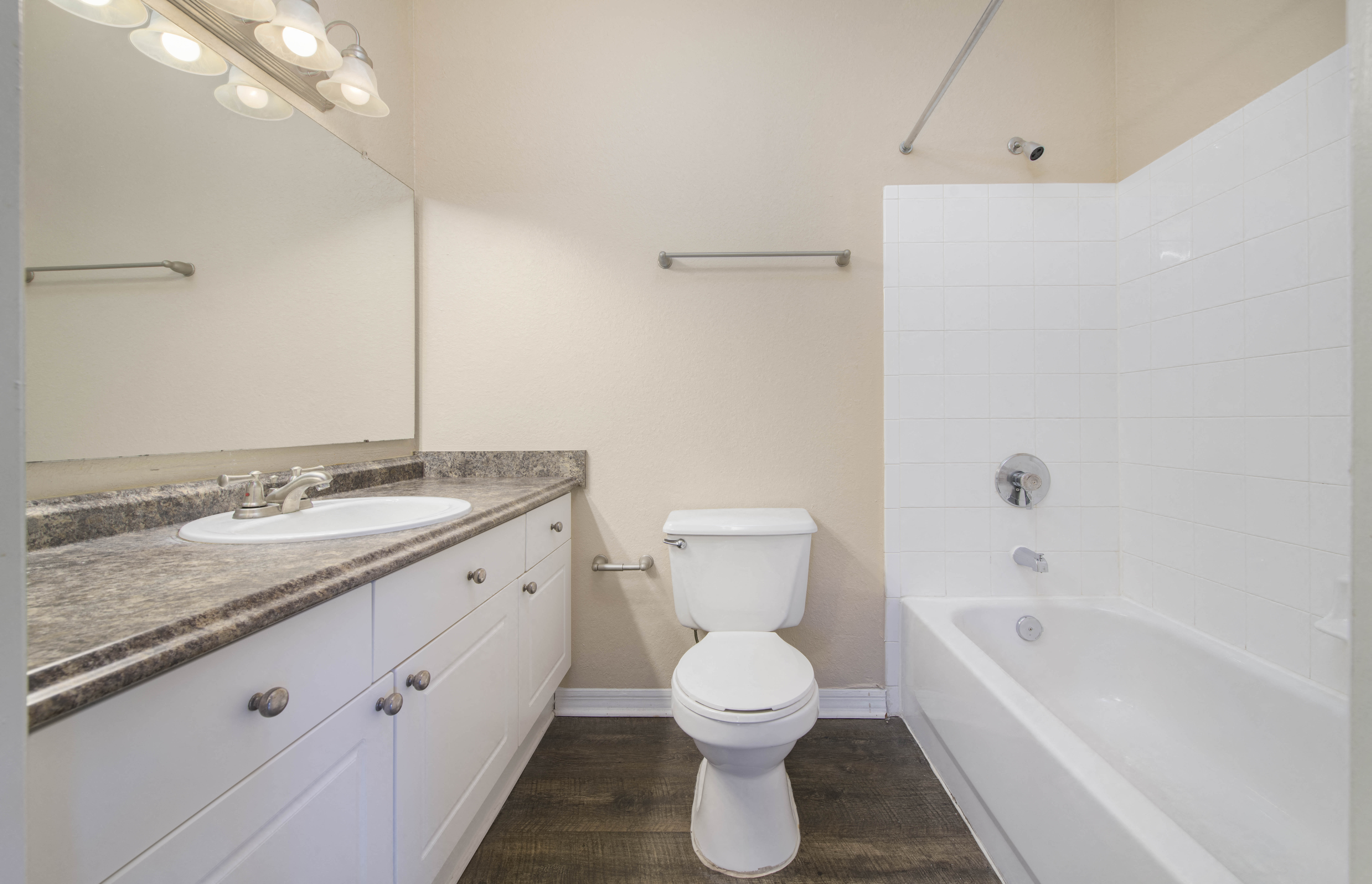 a bathroom with a toilet and a tub and a sink
