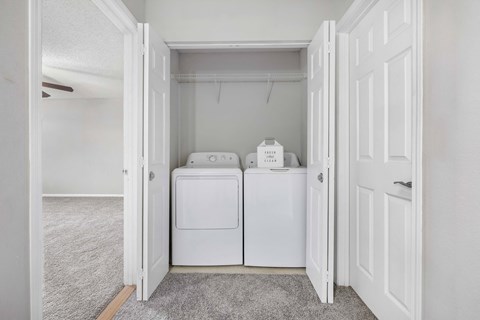 A white laundry room with a washer and dryer.
