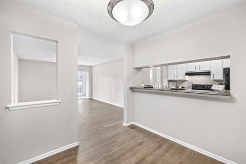 A room with a large mirror on the wall and a shelf with various items on it.