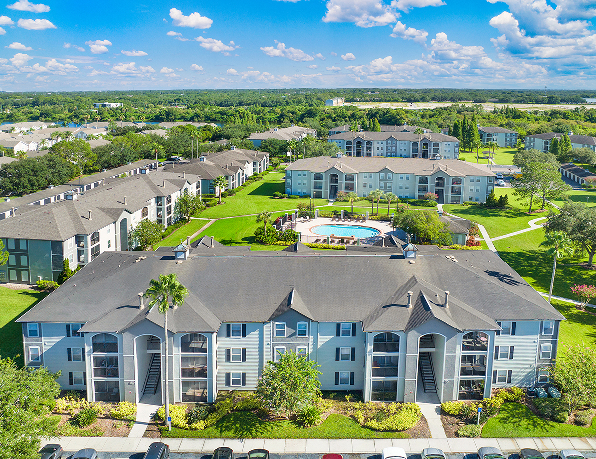 an aerial view of an apartment complex with a swimming pool