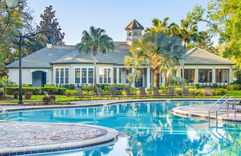 a large swimming pool in front of a house