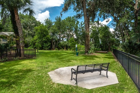 a park bench sitting in the middle of a grass field