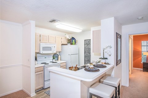 a kitchen with white appliances and a white counter top