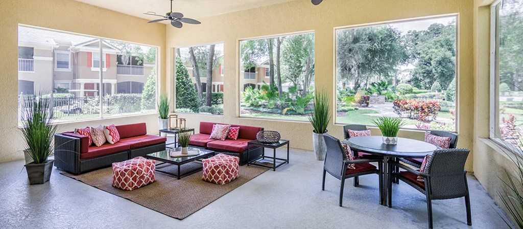 a living room with furniture and large windows