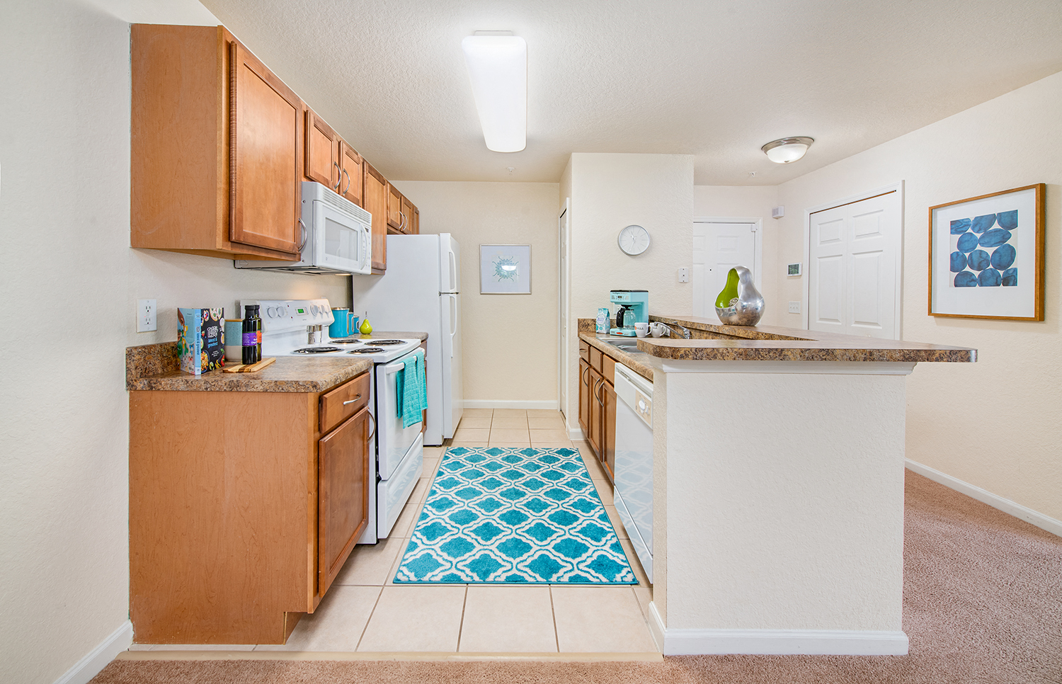 a kitchen with white appliances and wood cabinets