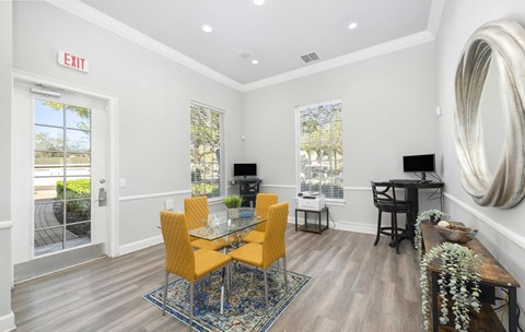 A dining room with a glass table and chairs.