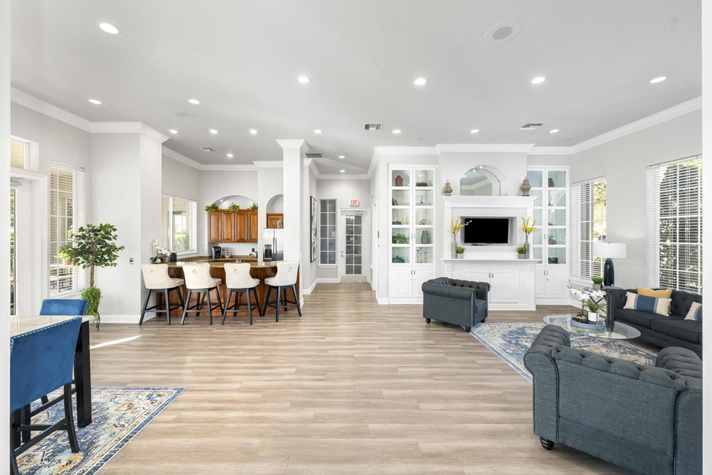 A spacious living room with a dining area and a kitchen in the background.