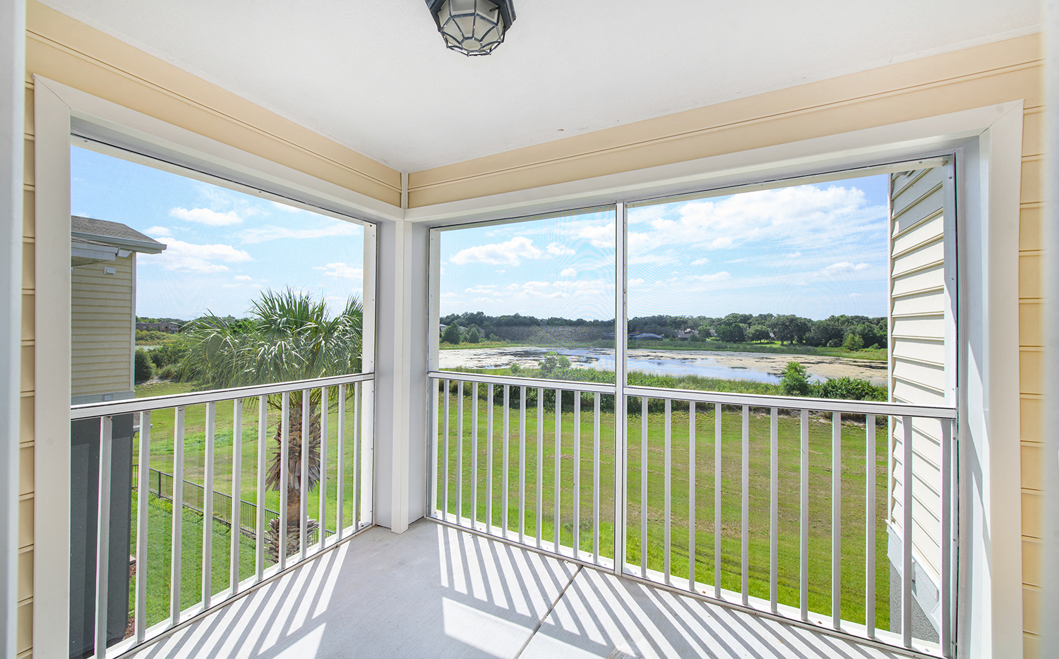 a balcony with a view of a body of water