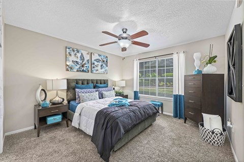 a bedroom with a bed and a ceiling fan