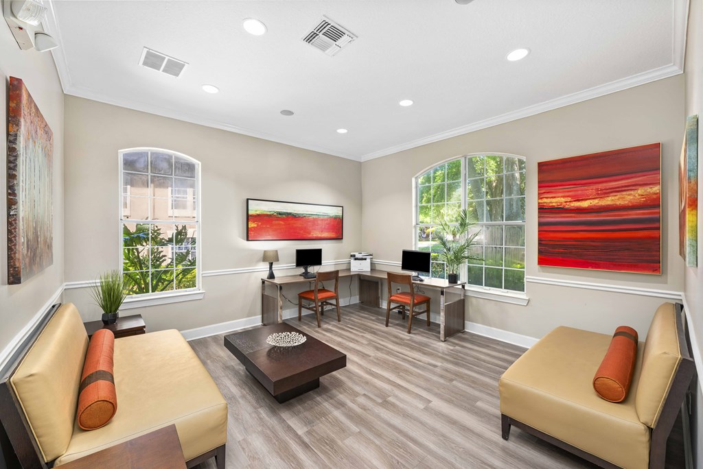 a living room with couches and a table with two windows