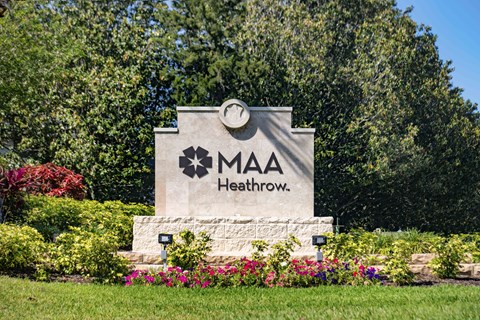 a monument with a sign that says in front of trees