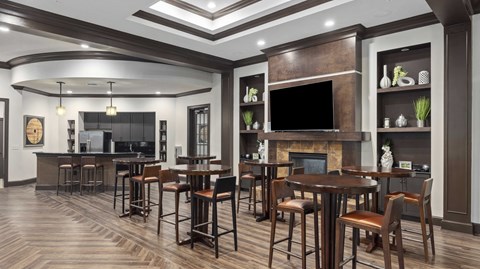 a large living room with tables and chairs and a fireplace