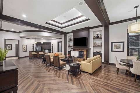 a living room with couches and chairs and a tv