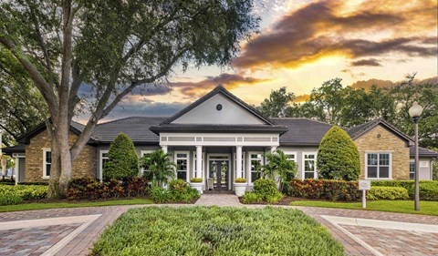 the front of a house with a sunset in the background