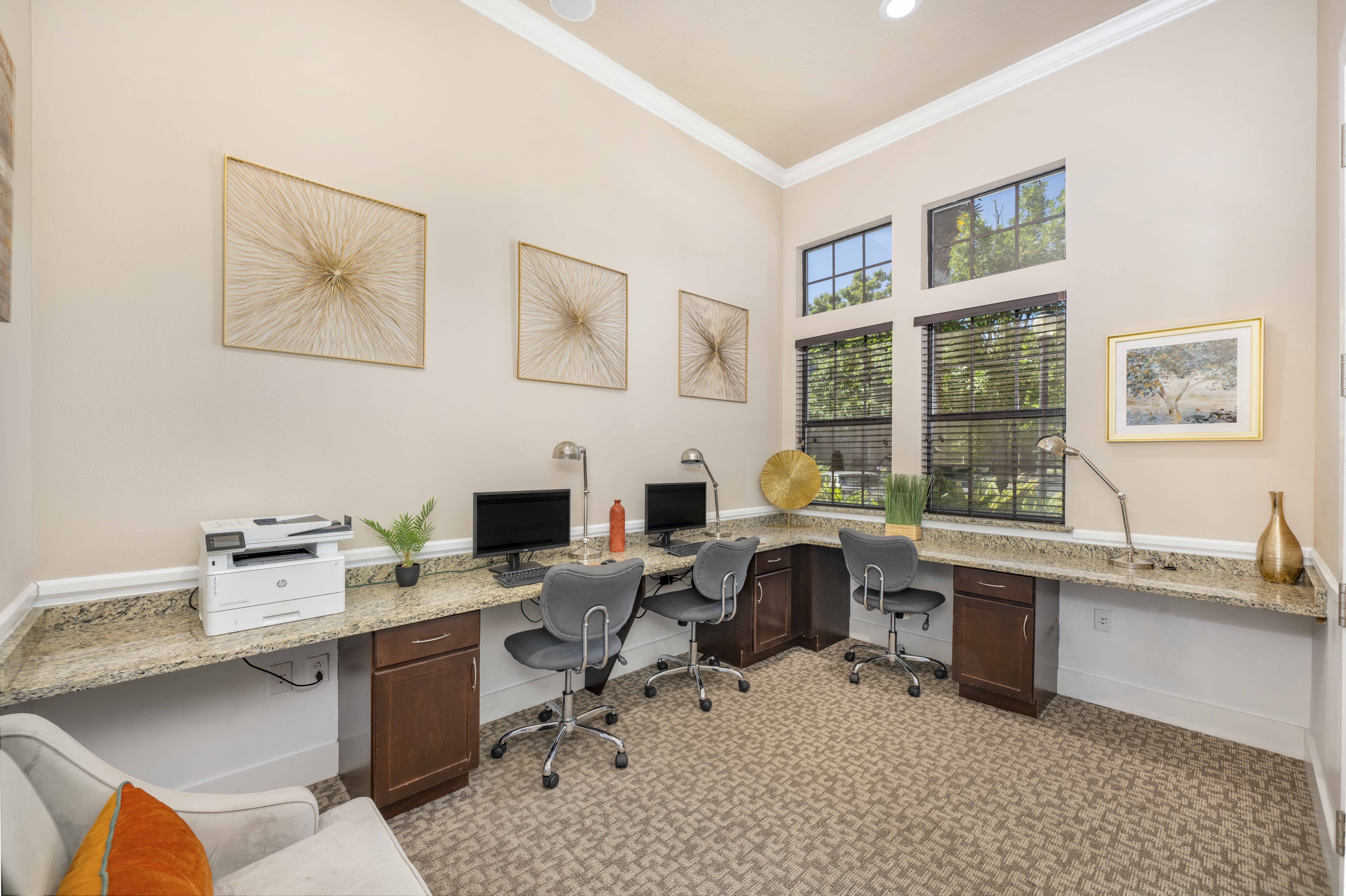 a home office with two desks and chairs and a printer