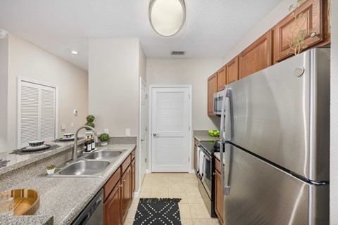 a kitchen with stainless steel appliances and granite counter tops